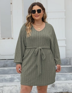 Detail of olive green ribbed knit dress featuring a V-neckline and tie waist belt