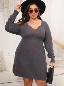 Close-up of charcoal gray knit dress showing hollow-out sleeve patterns and V-neck details