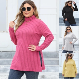 Detail showing the ribbed knit fabric texture and high side slit of this mock neck long top