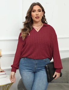 Detail of burgundy ribbed knit long sleeve polo shirt showing texture and V-neckline