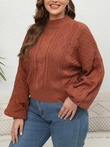Detail of chunky knit cable texture on caramel sweater with mock neck and puffed sleeves