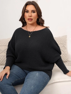 Detailed texture of women's black chunky knit sweater with batwing sleeves and boat neck