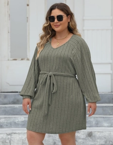 Close-up of olive green ribbed knit dress featuring a V-neck and stylish waist tie