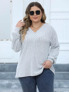 Close-up of light grey ribbed knit texture and V-neckline detail on a casual women top