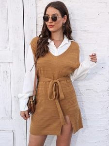 Close-up of caramel knitted vest dress with waist belt and side slit detail