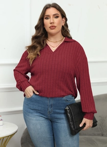 Detail of burgundy ribbed knit long sleeve polo shirt with V-neckline for women