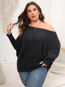 Detail of grey rib-knit texture on oversized off-shoulder sweater with batwing sleeves