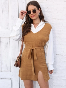 Detail of tan knitted V-neck vest dress with ribbed texture and side slit design