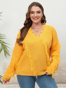 Detail of V-neck knitted sweater in yellow with fringe trim and distressed hollow design