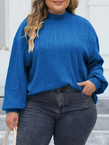 Detail of the navy blue mock neck rib-knit top showing the soft elastic texture