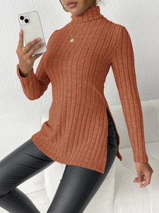 Detail view of orange-brown ribbed knit turtleneck sweater with stylish side slit design
