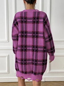 Back view of a long oversized purple plaid sweater dress with distressed hem detail