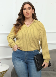 Close-up of mustard yellow polo neck knit top with vertical ribbed texture and gold necklace