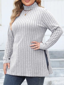 Detail view of grey knit top featuring ribbed texture and side slit hem design