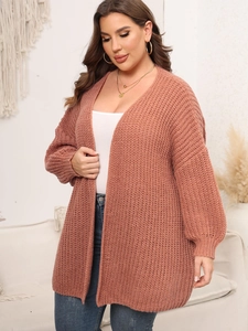 Detail of chunky knit texture and puff sleeves on long dusty pink cardigan sweater