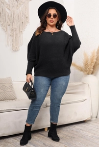 Detail of oversized black knit sweater with batwing sleeves and ribbed texture