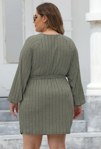 Detail of olive green ribbed knit dress featuring a waist belt and long sleeves