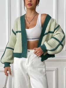 Detail of green color-block knitted cardigan showing texture and high-quality stitching