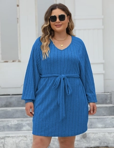 Close-up of blue ribbed knit dress with V-neckline and tie-waist belt detail