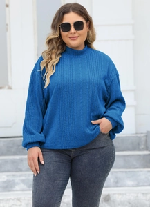 Detail of royal blue ribbed knit texture on women high neck sweater in outdoor setting