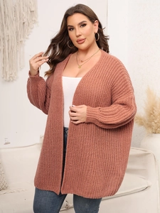 Detail of chunky knit texture on a brick red oversized cardigan for women