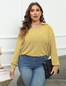 Close-up of ginger yellow ribbed knit top featuring a polo collar and V-neckline detail