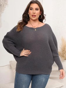 Close-up of charcoal grey off-shoulder knit sweater with horizontal ribbing and loose fit