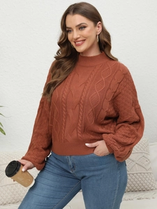 Close-up of caramel cable knit sweater featuring a high collar and loose lantern sleeves