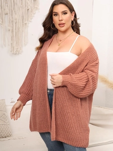 Close-up of chunky knit pattern and ribbed cuff on a dusty pink oversized cardigan