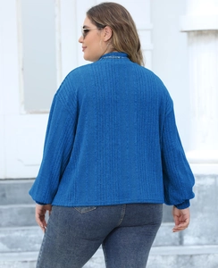 Detail view of royal blue ribbed knit texture and puff lantern sleeves on a plus size top