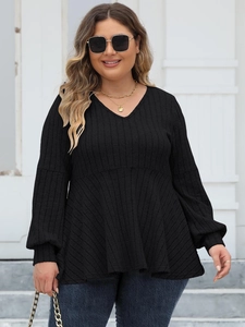 Detail of V-neck ribbed fabric and lantern sleeve design on this black women's tunic top