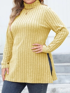 Detail of yellow ribbed turtleneck top featuring side slits and slim fit knit texture