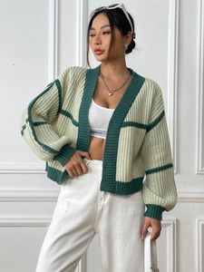 Detailed close-up showing the textured knit pattern and contrast stitching of the cardigan
