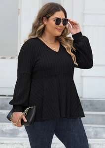 Detail of plus size black V-neck top with ribbed knit texture and puff lantern sleeves