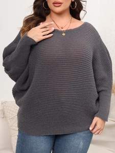 Detail of dark grey oversized knit sweater with batwing sleeves and ribbed texture