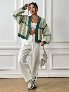 Detail of chunky knit texture on mint green striped cardigan with ribbed cuffs