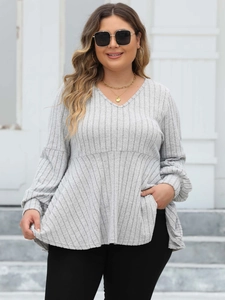 Close-up of light gray ribbed fabric on a V-neck tunic top with pleated lantern sleeves