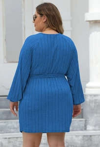 Detail of royal blue ribbed knit dress showing fabric texture and tie waist belt