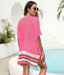 Detail of rose pink crochet beach cover-up with side split and colorful striped hemline