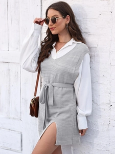 Elegant grey knitted long vest with side slits and waist belt over a white shirt