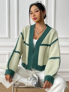 Detail showing the chunky knit texture and green color-block stripes on the women's cardigan