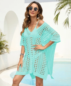 Detail of mint green crochet beach cover-up with openwork diamond pattern and V-neck