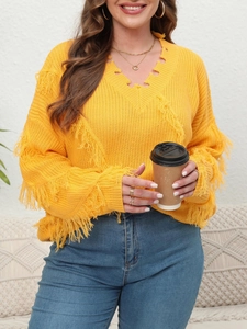 Detail of yellow V-neck knit sweater featuring distressed fringes and knitted textures