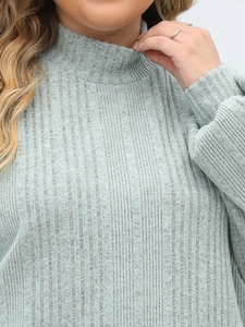 Detail of mock neck ribbed knit sweater featuring high-quality sage green textured fabric