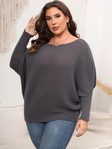 Detail of grey oversized batwing sleeve sweater with boat neck and knit texture