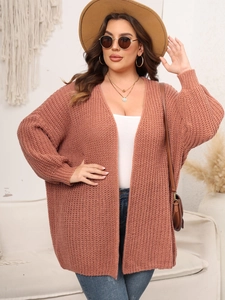 Detail view of chunky brick red knit cardigan with relaxed drop shoulder and soft texture