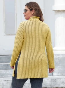 Detail of ginger yellow ribbed knit top featuring a high neck and stylish side slits
