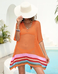 Detail of crochet beach cover-up featuring colorful striped hem and V-neck knit mesh