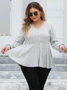 Detail of light gray V-neck peplum top featuring textured vertical stripes and soft fabric