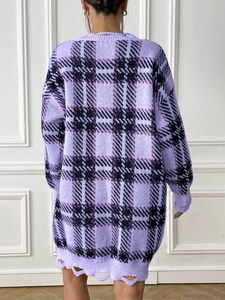 Back view of oversized purple plaid knit sweater with distressed hem and frayed details